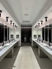 a large bathroom with sinks and mirrors