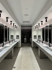 a large bathroom with sinks and mirrors