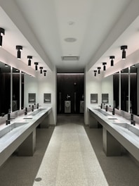 a large bathroom with sinks and mirrors