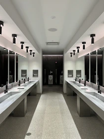 a large bathroom with sinks and mirrors