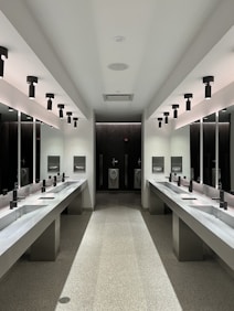 a large bathroom with sinks and mirrors