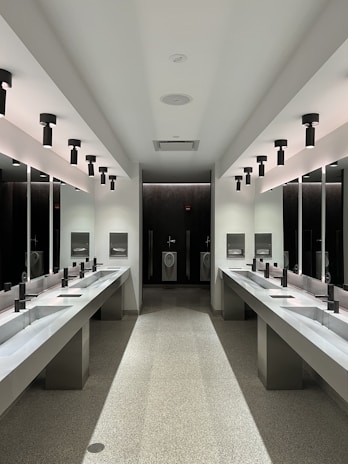 a large bathroom with sinks and mirrors
