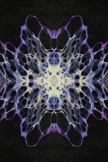 Close-up of a kaleidoscopic pattern with rich purples, blues, and pinks merging