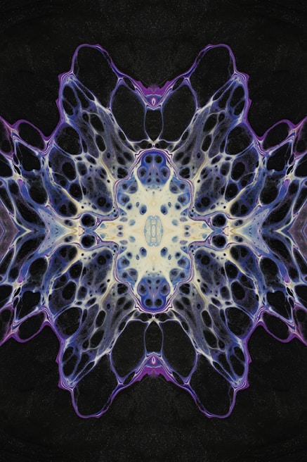 Close-up of a kaleidoscopic pattern with rich purples, blues, and pinks merging