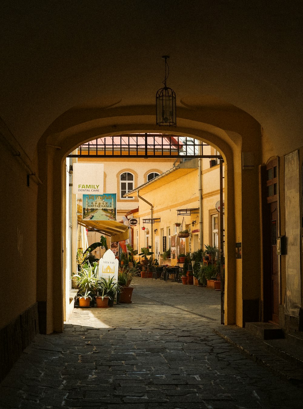 a stone walkway with a light above it