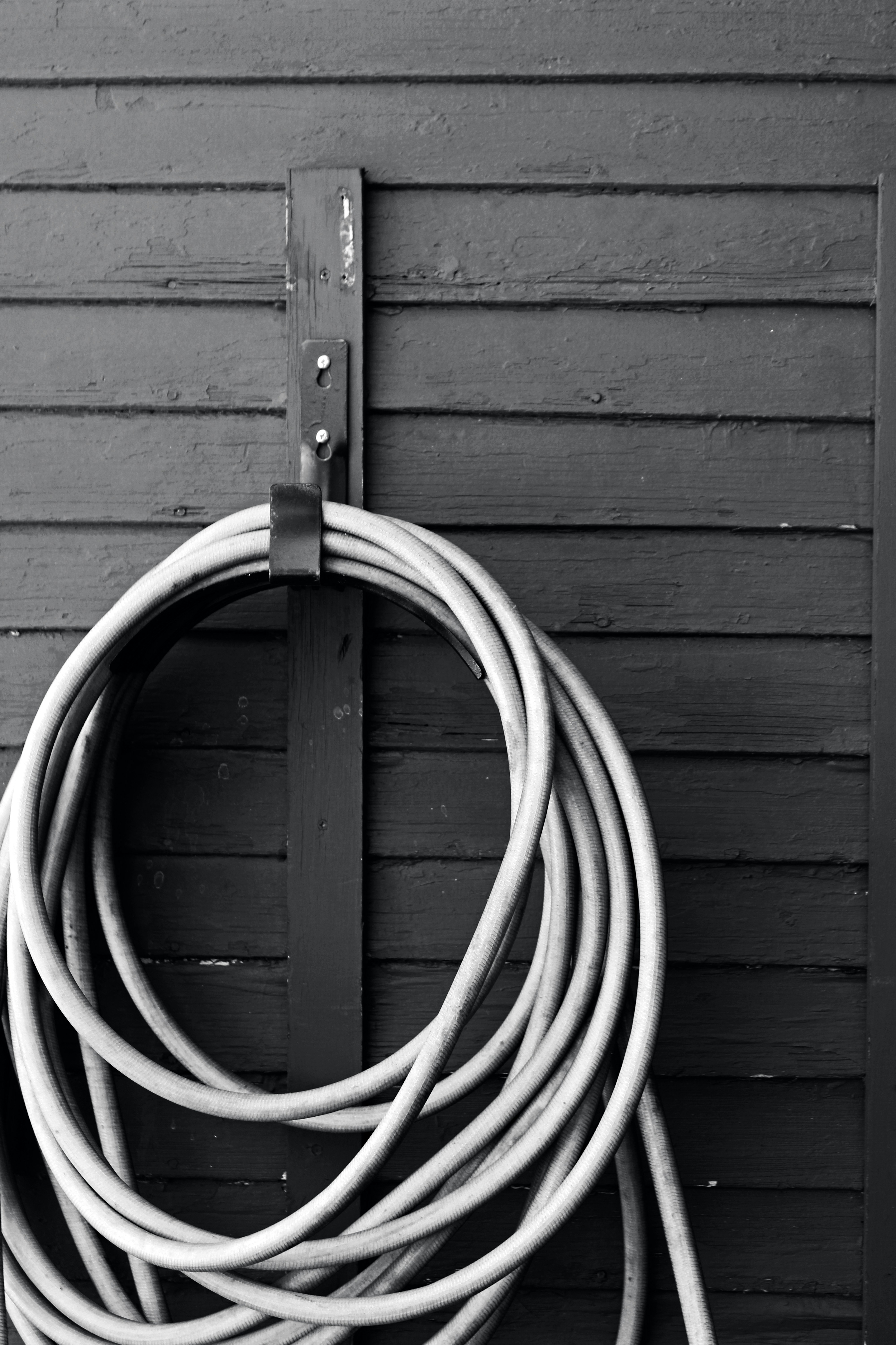 a white rope tied to a wooden wall