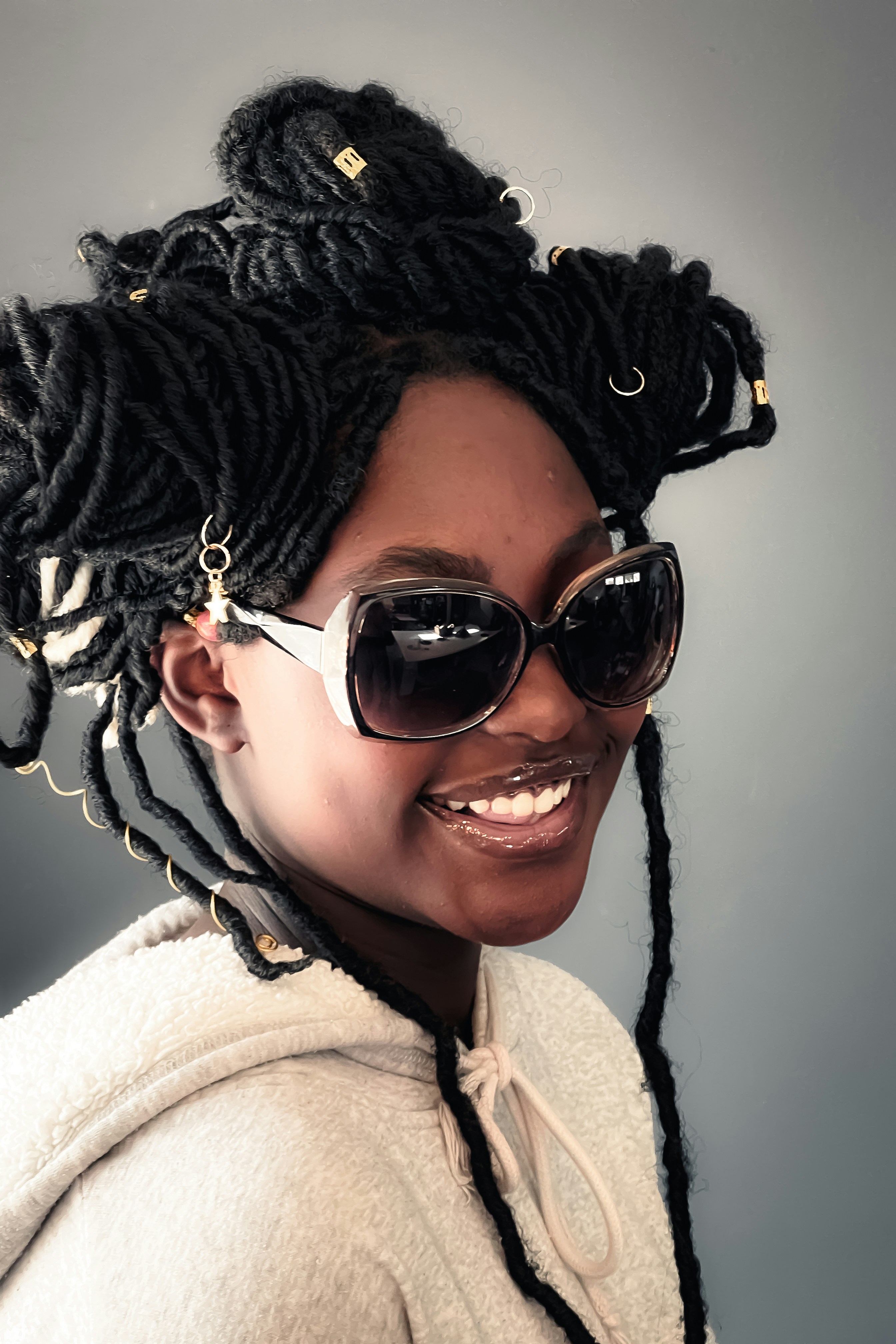 a person wearing sunglasses and a furry hat