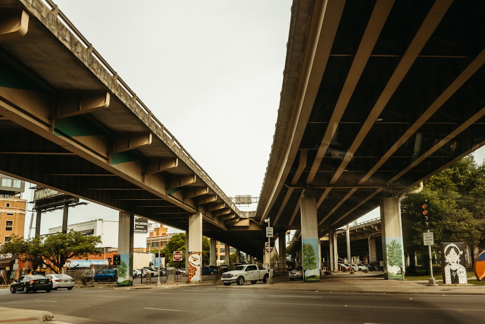 a street with cars and a bridge