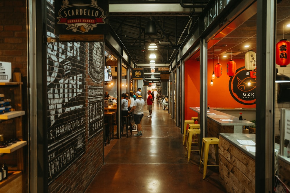 a group of people walking through a restaurant