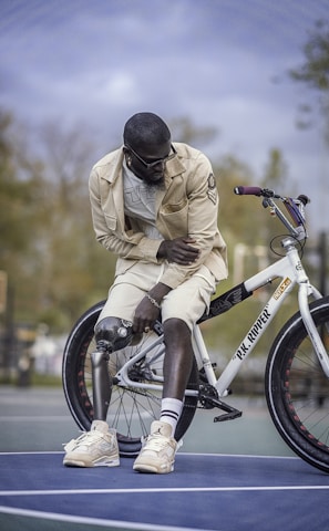 man with prosthetic sitting on a bicycle