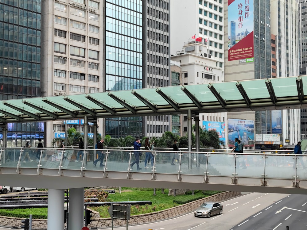 a street with a bridge over it and buildings in the back