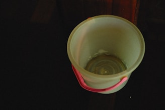 Close-up of a sturdy plastic bucket with a secure lid and handle.