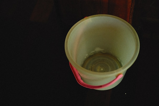 Close-up of a sturdy plastic bucket with a secure lid and handle.