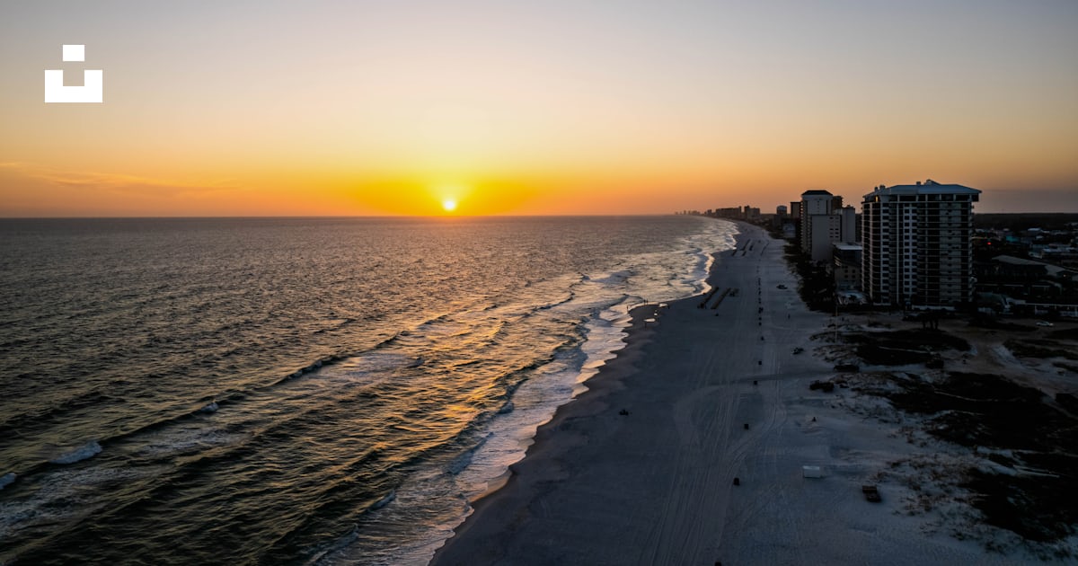 A beach with buildings and water photo – Free Panama city beach Image