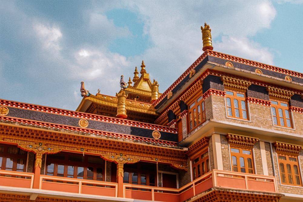 a building with a gold statue on top