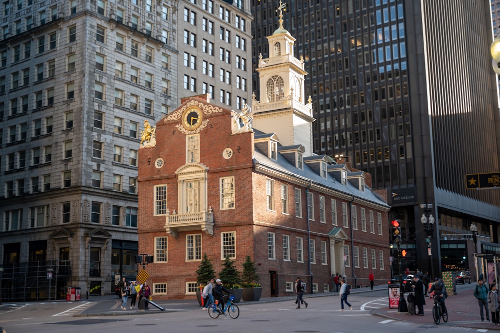 a brick building with a clock tower with Old State House in the background