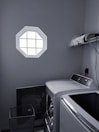 A laundry area with modern appliances.
