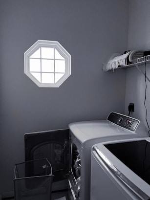 An inviting laundry area with neatly folded linens and a clean washer-dryer set, reflecting careful attention to detail.