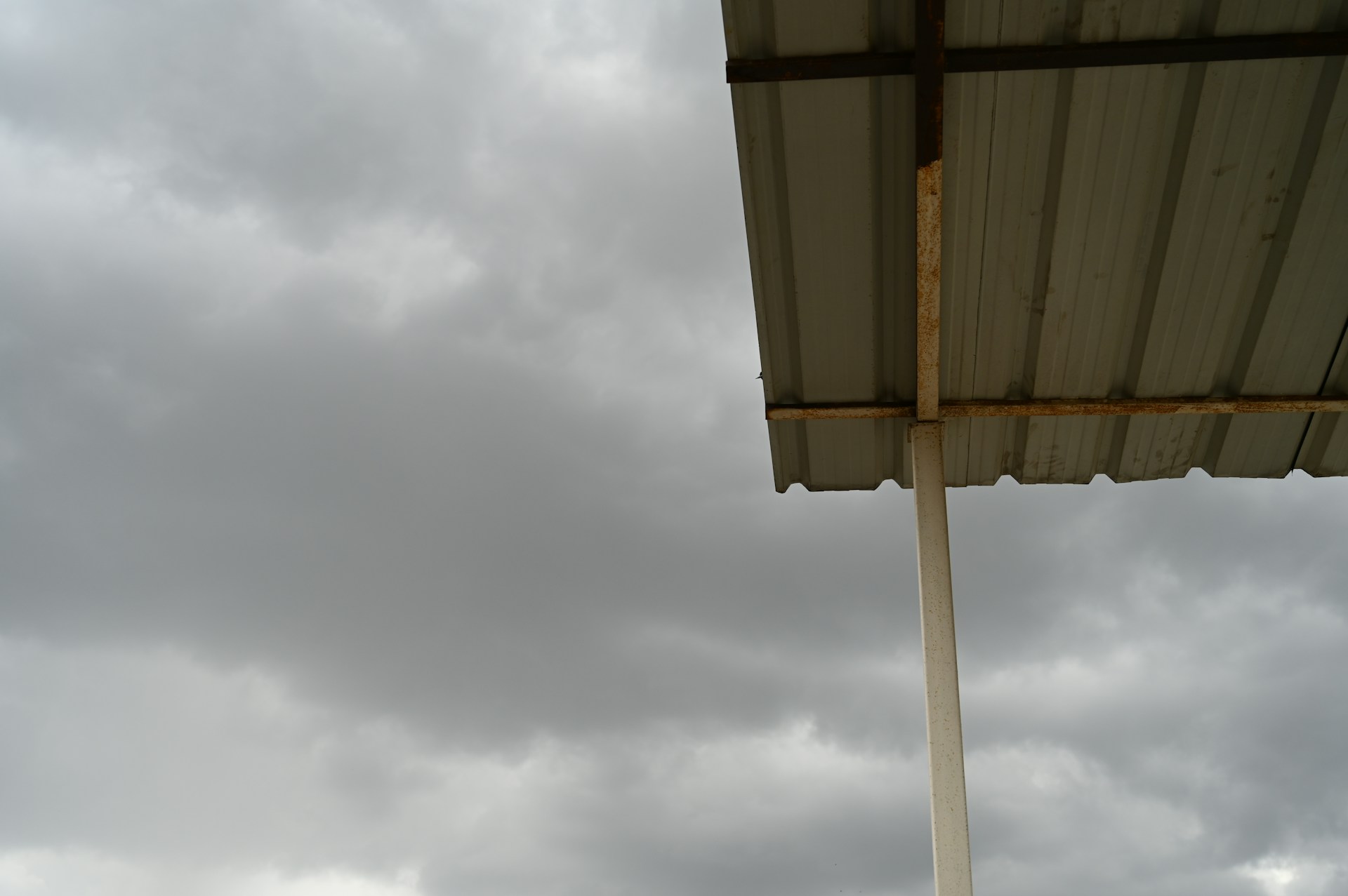 woman wearing yellow long-sleeved dress under white clouds and blue sky during daytime