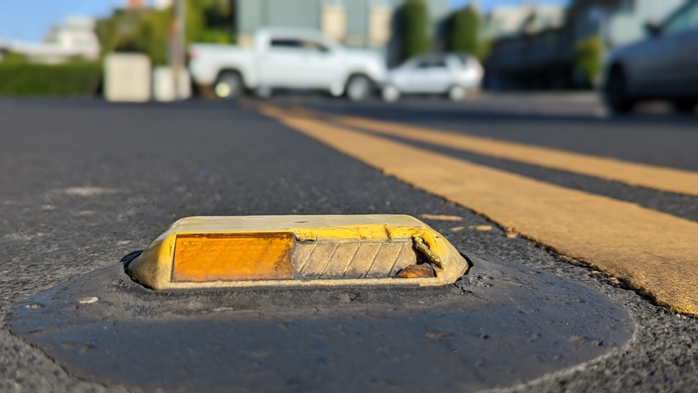 a yellow rectangular object on a road