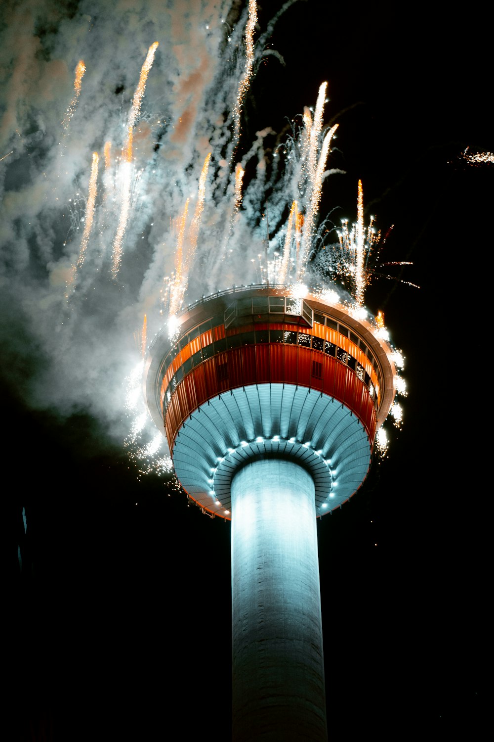 a large tower with fireworks in the background