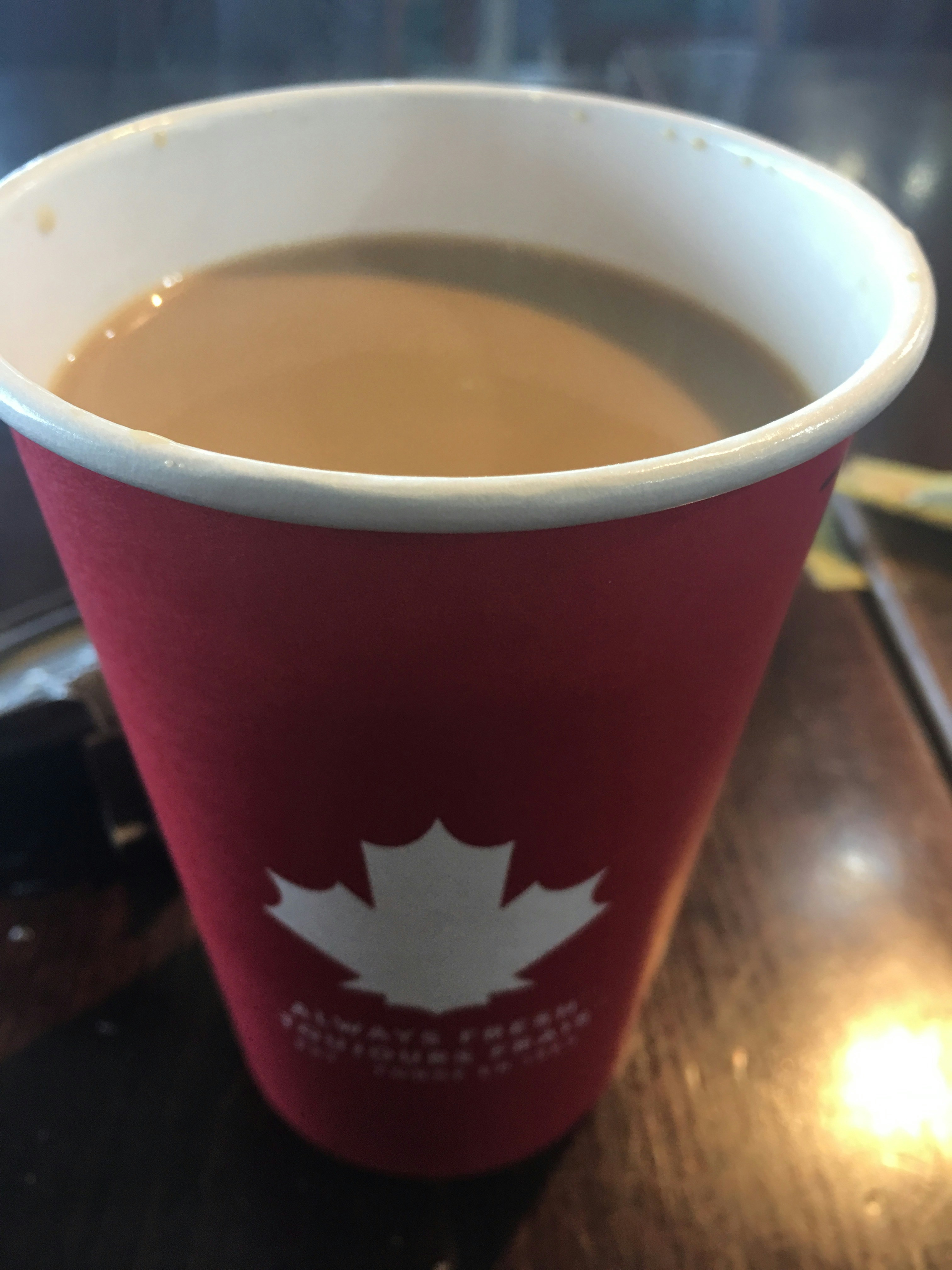 canadian flag with a coffee cup