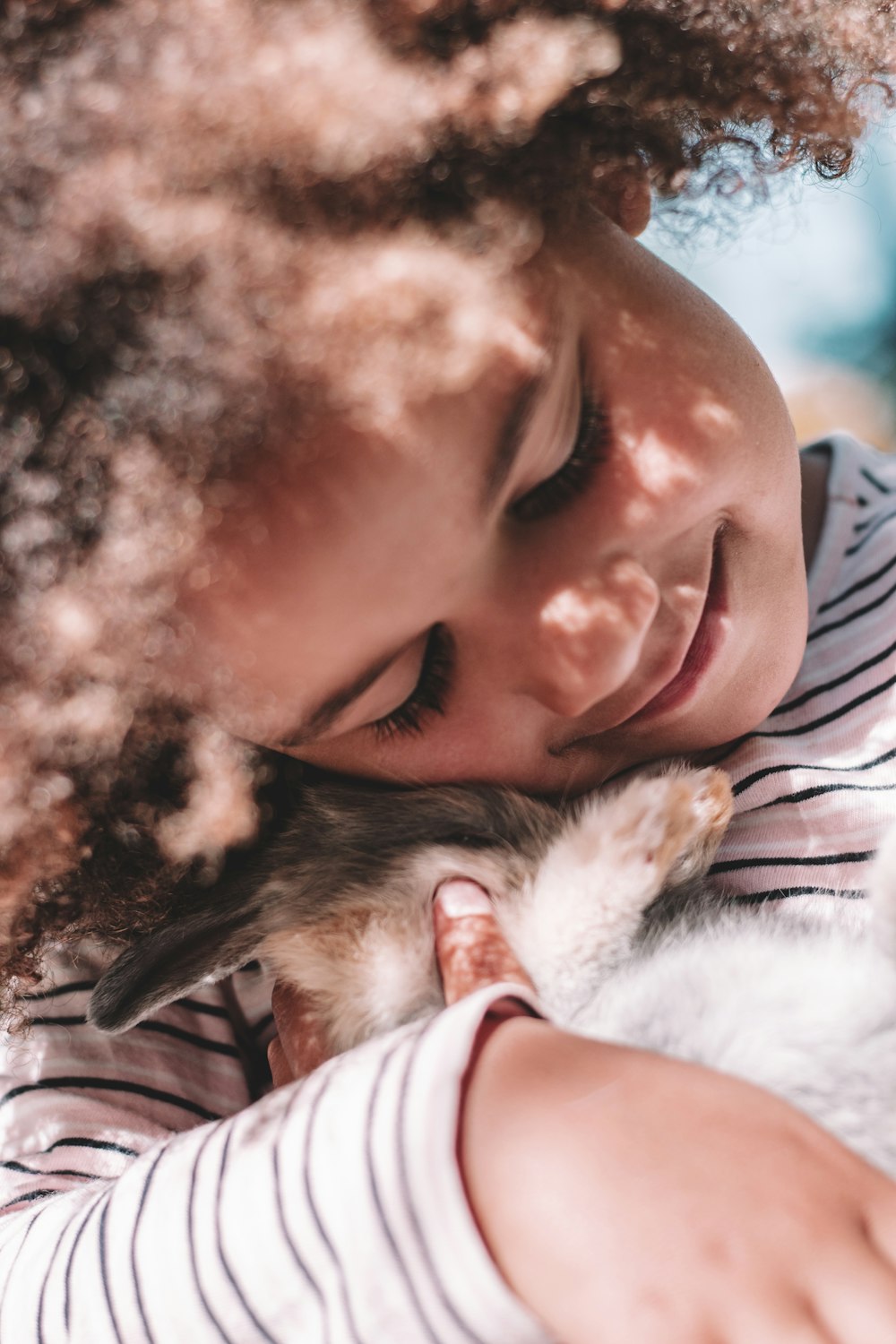 a person kissing a dog