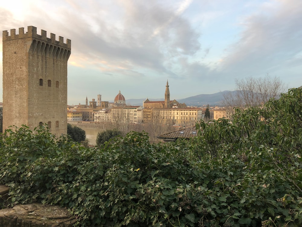 a large building with towers and a city in the background