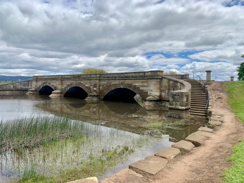 a stone bridge over a river