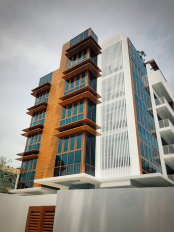 Exterior view of a sleek multi-unit commercial modular building with large windows and natural wood accents.