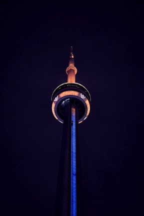 A Fortnite build battle captured mid-action with structures glowing in electric blue against a dark background