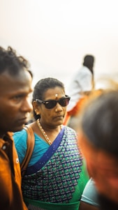 A vibrant photo of Indian men and women in Borivili East wearing colorful eyeglasses and sunglasses, smiling under natural light.