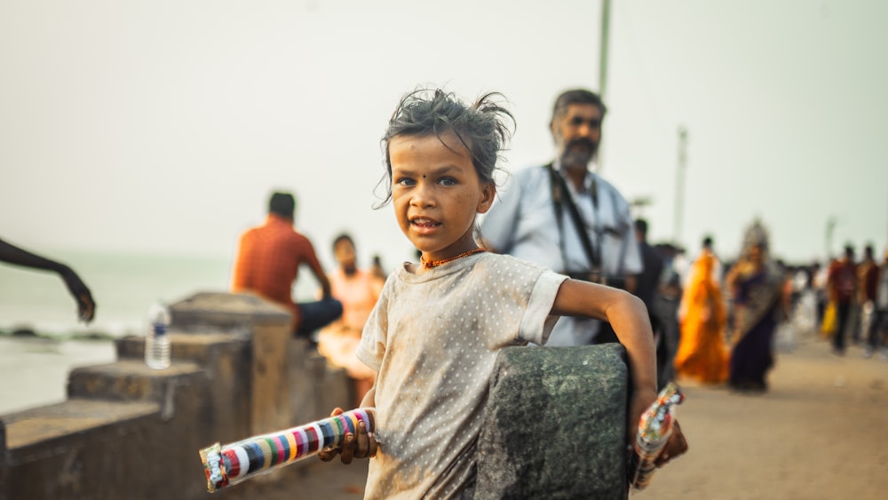 a child with a group of people behind her