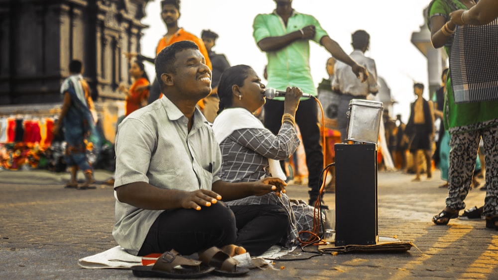 a few men sitting on the ground