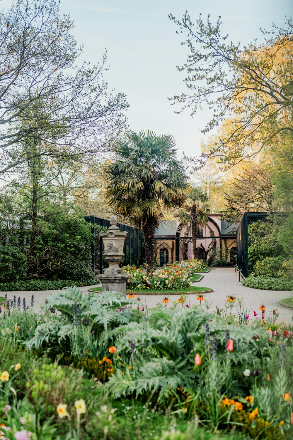 a garden with a statue in the center