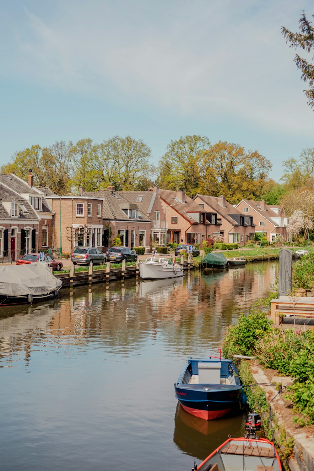 a group of boats parked on the side of a river