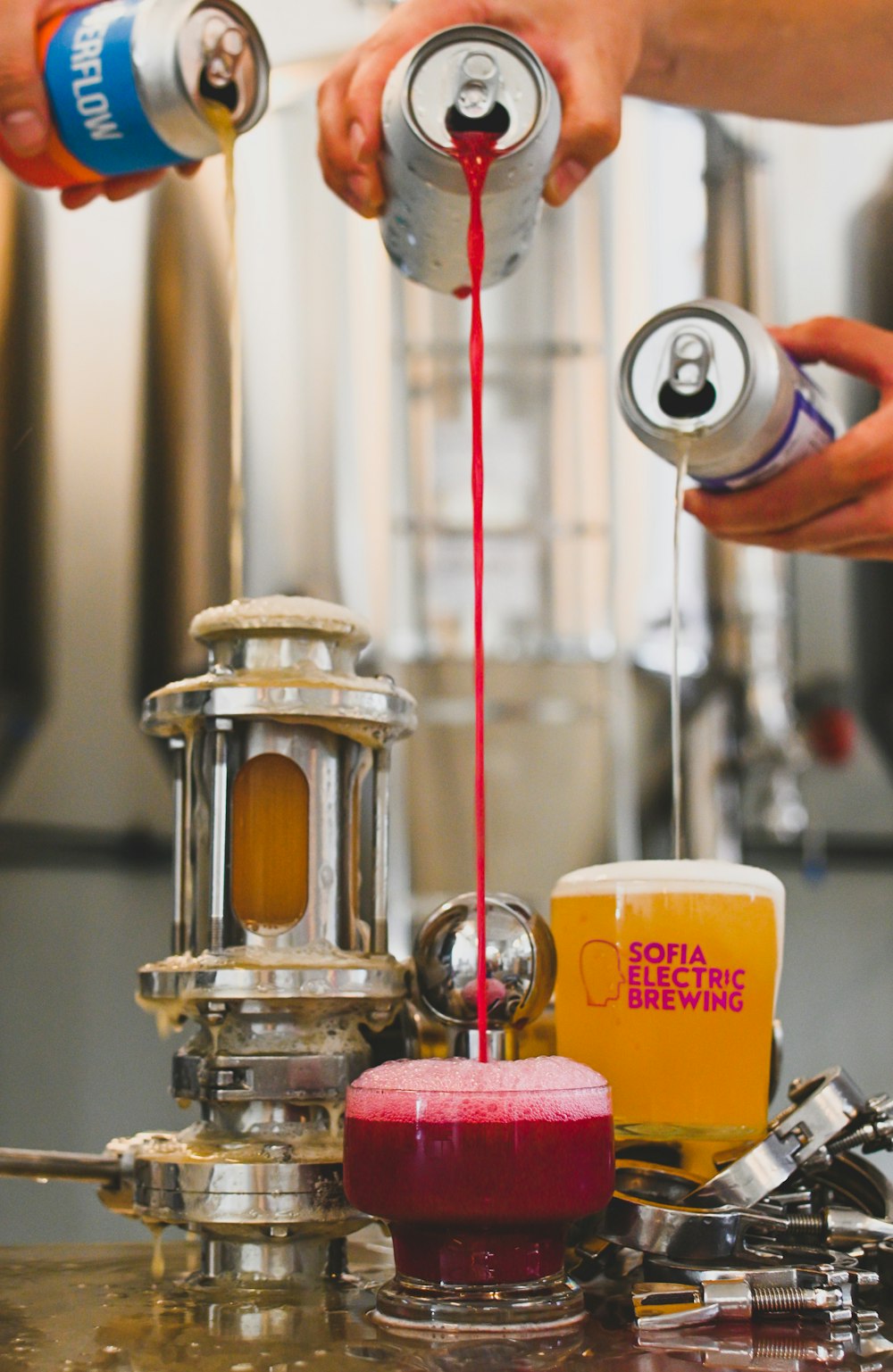 a person pouring liquid into a glass