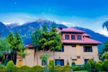 a large house with trees in front of it