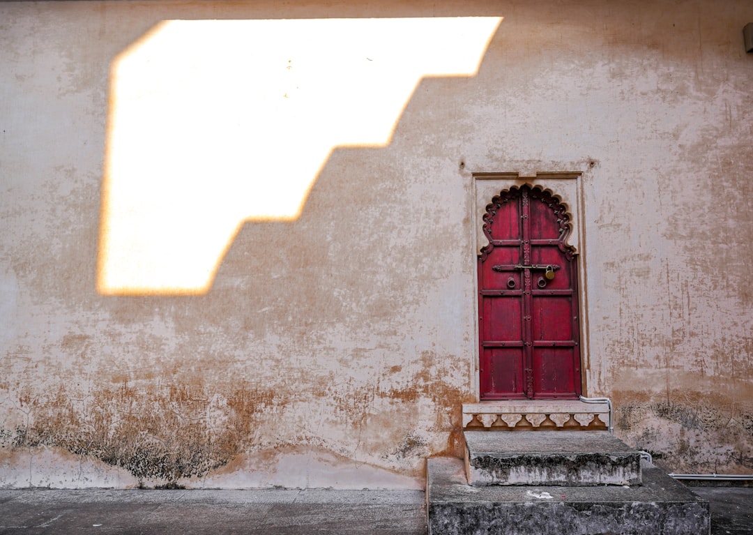 a red door in a stone building,