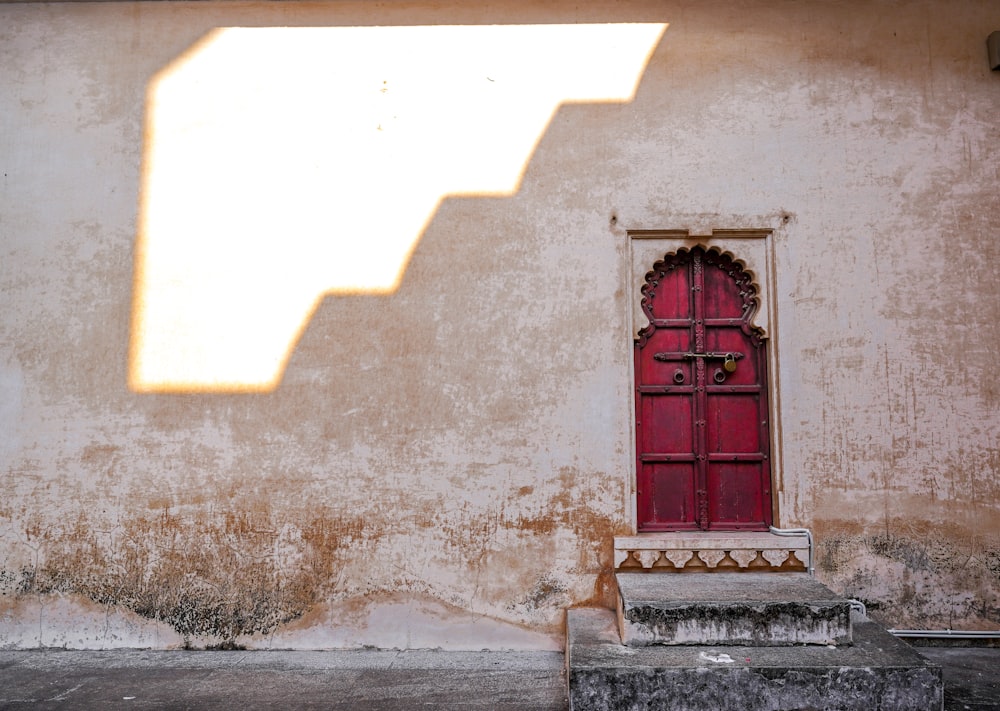 a red door in a stone building