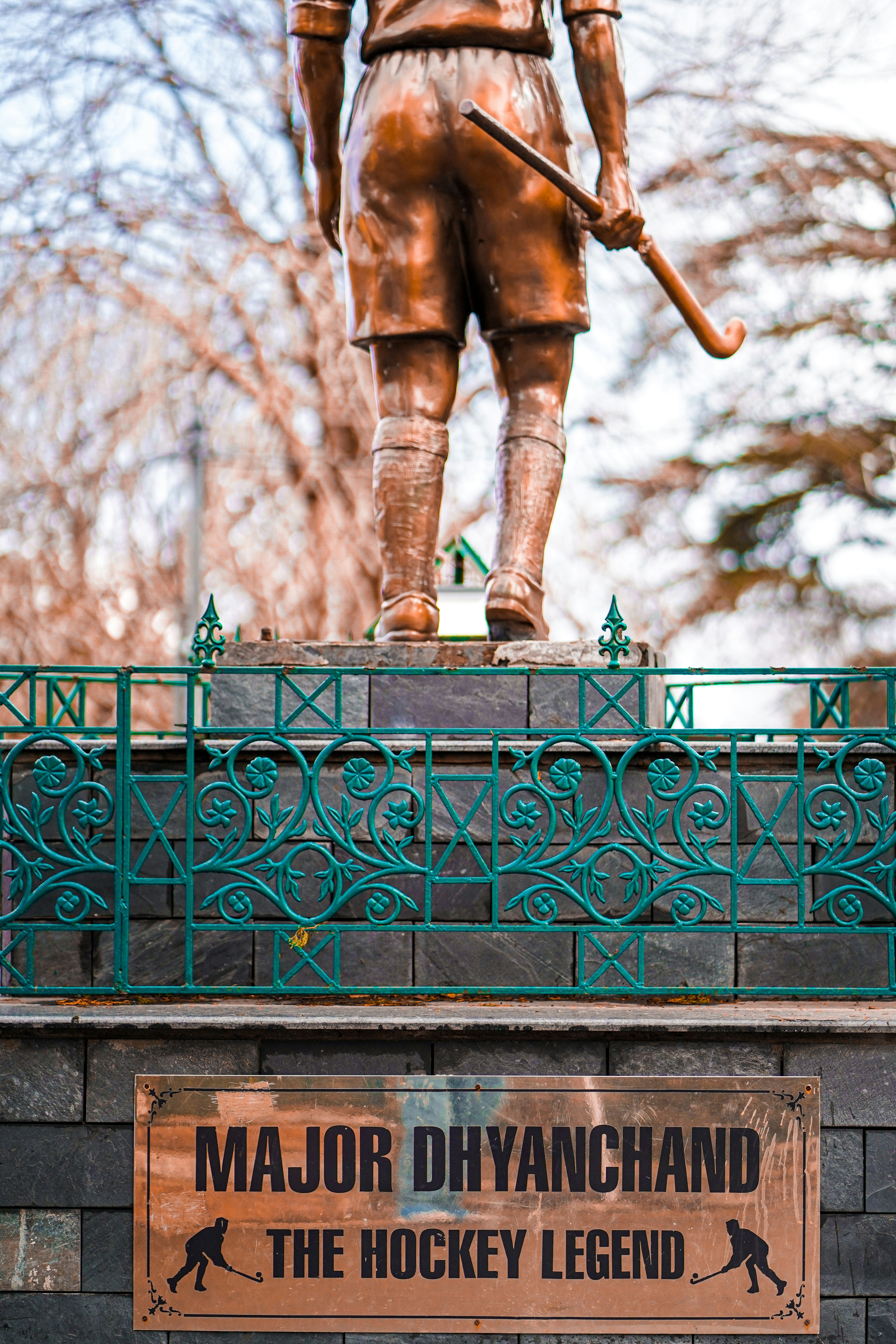a statue of a person holding a sword on a railing