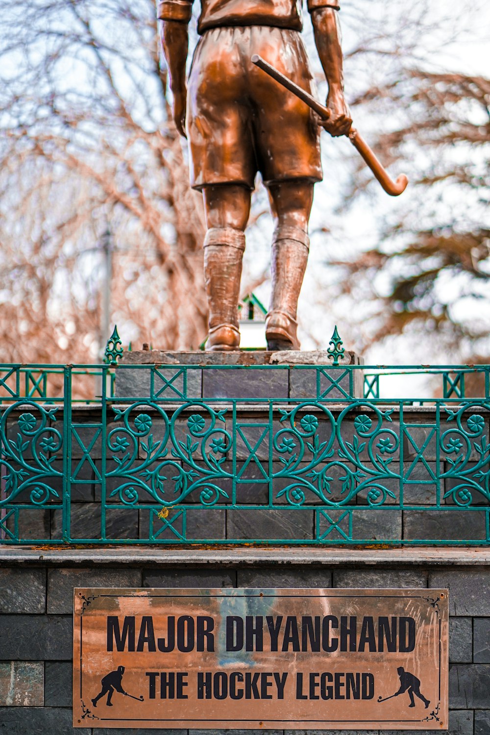 a statue of a person holding a sword on a railing