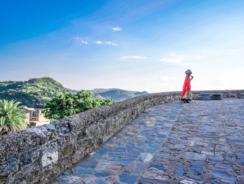 a person standing on a stone wall