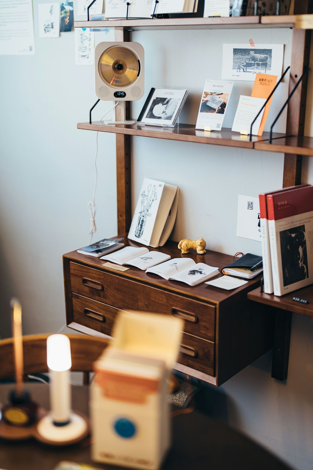 a desk with a lamp and books on it