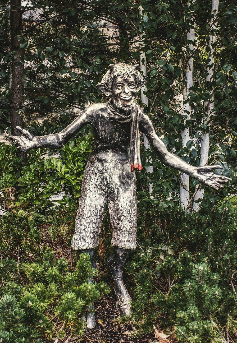 a statue of a person holding a tree branch