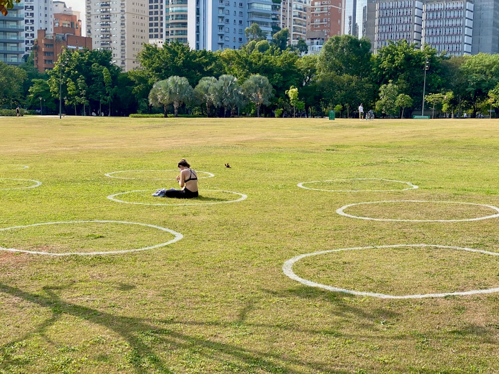 a person sitting on a grassy field