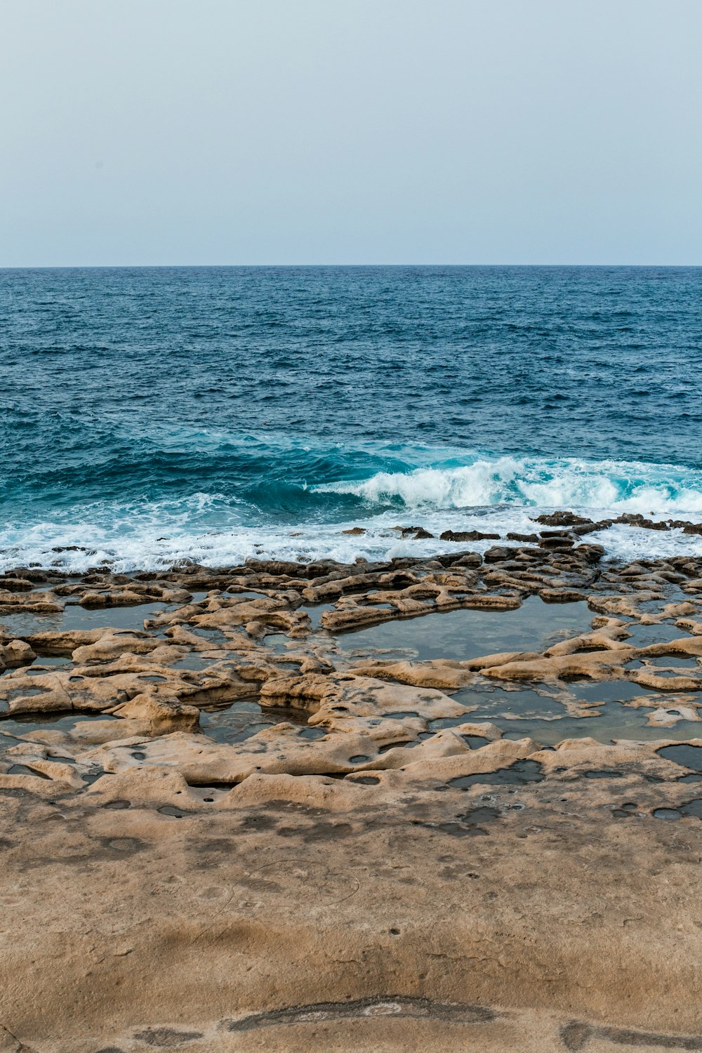 a rocky beach with waves crashing