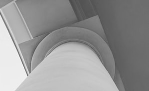 a white staircase with a grey wall