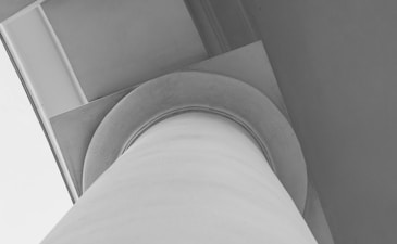 a white staircase with a grey wall