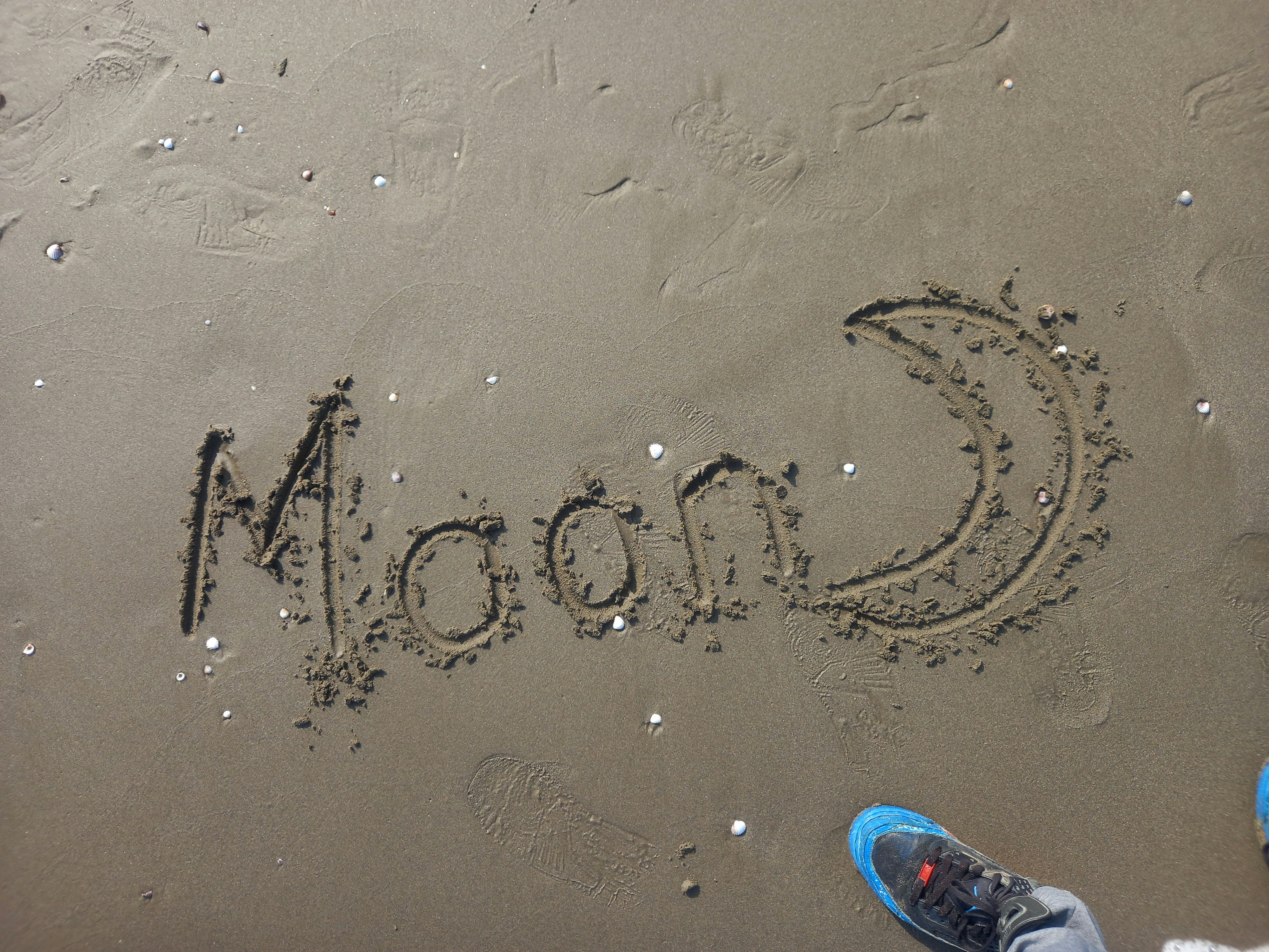 a beach with writing in the sand